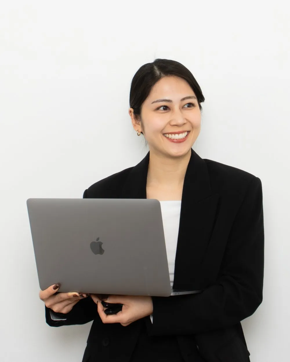 Suzuna Saito, founder of Studio Novo, holding a laptop